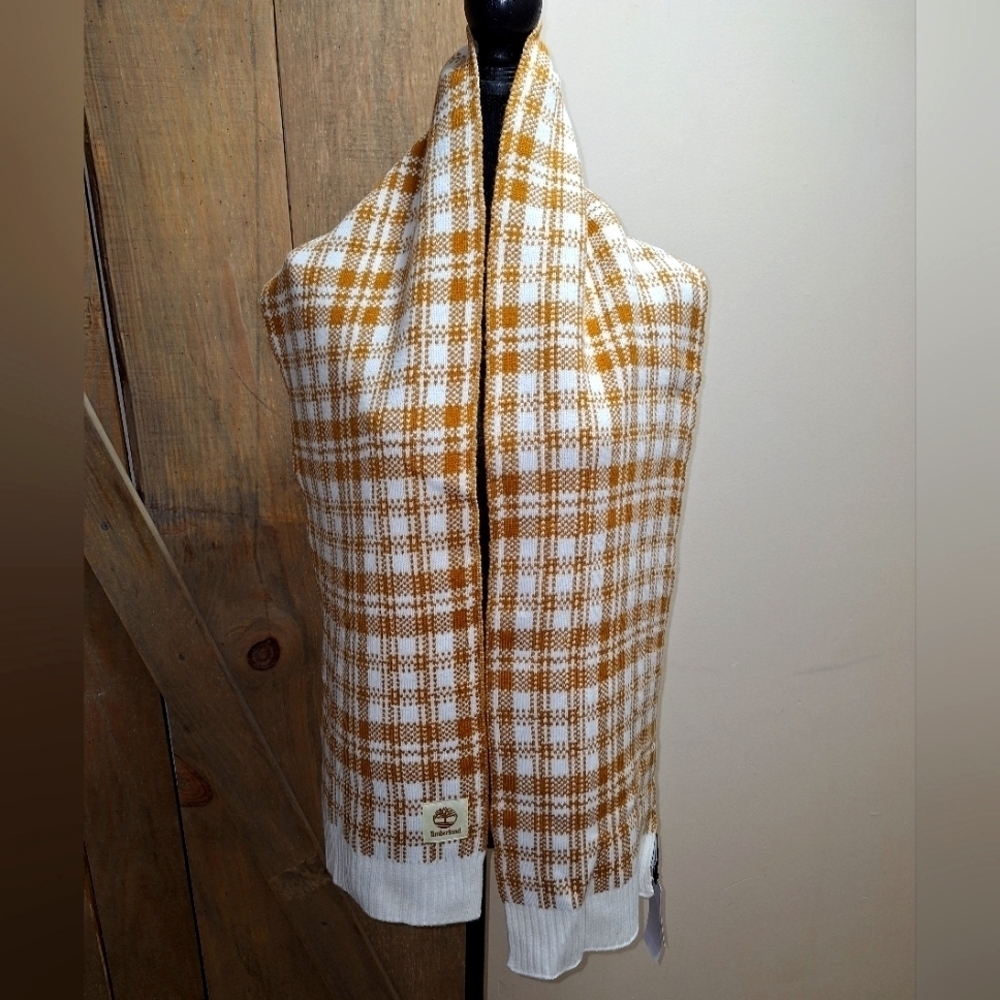 A Timberland white/ lt. brown plaid scarf that's 67" long and 9.5" wide. NWT.